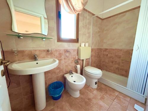 a bathroom with a sink and a toilet at Hotel Costa Doro - Salve in Salve