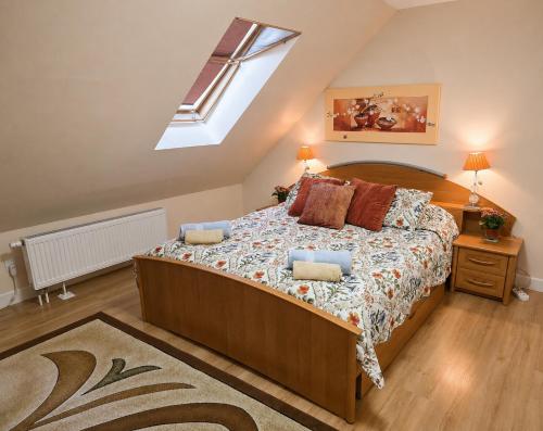 a bedroom with a large bed with a skylight at Agroturystyka Staroscin in Rzepin