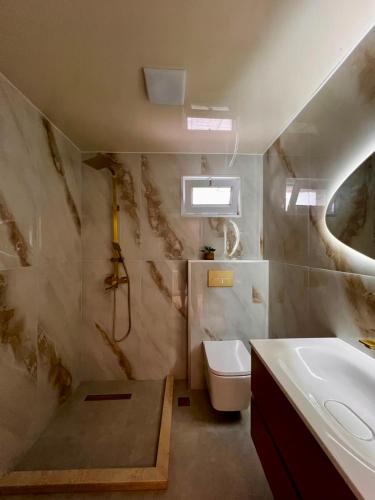 a bathroom with a sink and a toilet and a tub at Botanic sea view in Batumi