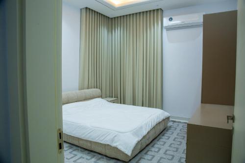 a small bedroom with a bed and a window at Ubar-Salalah in Salalah