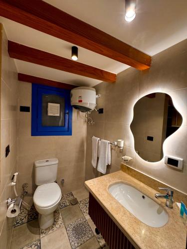 a bathroom with a toilet and a sink and a tub at Naama Lofts in Sharm El Sheikh