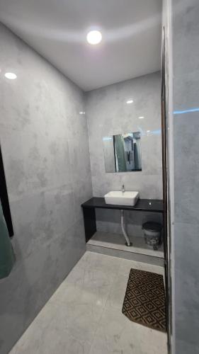 a bathroom with a sink and a mirror at Global Stay Mantralayam in Mādhavaram
