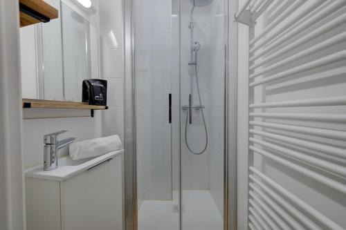 a white bathroom with a shower and a sink at Viktor 3 - Hyper Centre - Place Jean Jaurès in Tours