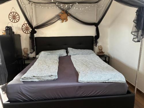 a bedroom with a bed with a canopy at Terra in Valledoria