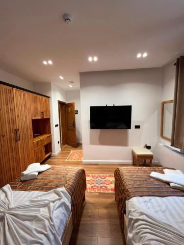 a hotel room with two beds and a flat screen tv at Gurra resort in Klos