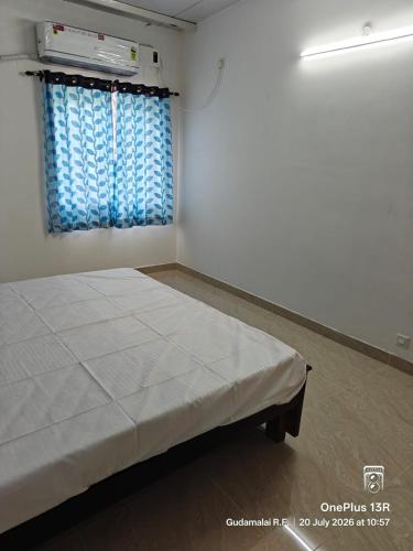 a white room with a bed and a window at Coco Kudil - FARM STAY in Salem