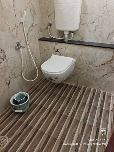 a bathroom with a toilet and a shower at Coco Kudil - FARM STAY in Salem