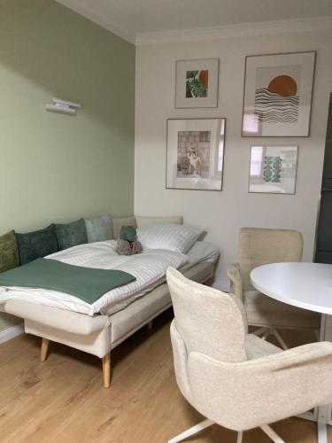 a bedroom with a bed and two chairs and a table at Apartment Marktgeflüster in Bad Düben