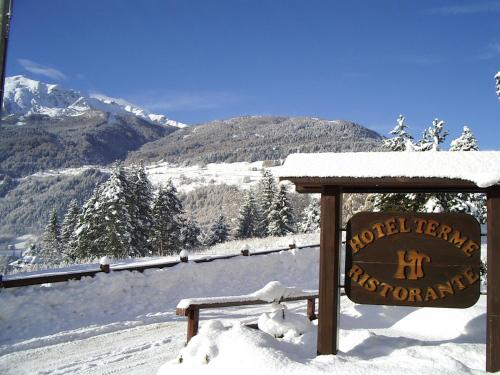 a sign on top of a snow covered mountain at Hotel Terme in Bormio