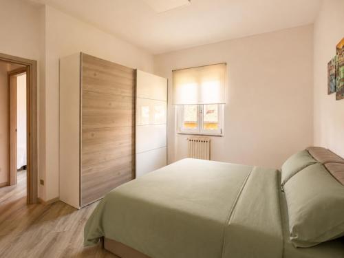 a bedroom with a large bed and a window at Rocca Lake House in Angera