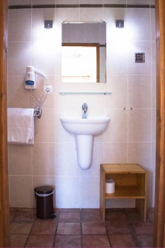 a bathroom with a sink and a window at Chambres à la Table du Curé in Cucugnan