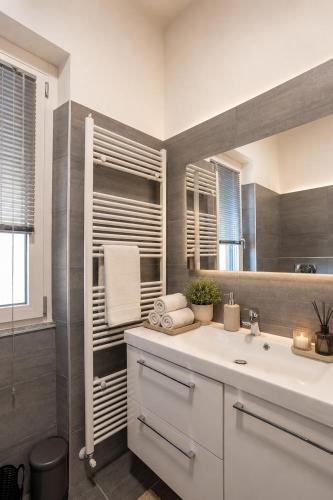 a bathroom with a sink and a mirror at Rocca Lake House in Angera