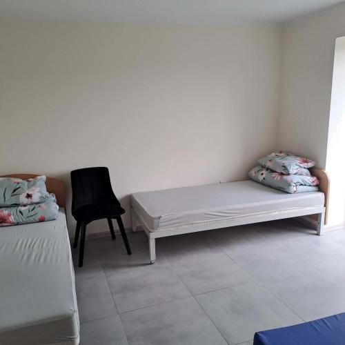 a room with a bed and a chair in it at Domki nad Nidą in Wiślica