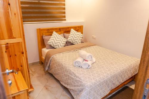 a bedroom with a bed with two towels on it at بوابة الشمس 2 in Agadir