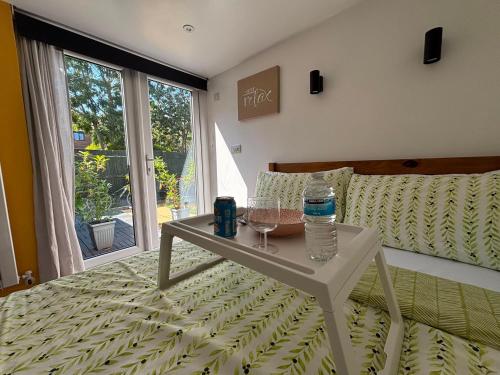 a room with a bed with a table and a window at Private Guest Suite in Bletchley, Milton Keynes in Bletchley