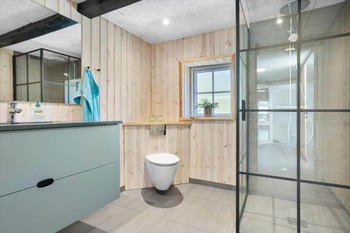 a bathroom with a toilet and a glass shower at 1388-Snedsted-Kaergardsvej-30 in Nørhå