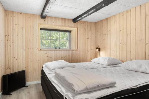 a bedroom with two beds and a window at 1388-Snedsted-Kaergardsvej-30 in Nørhå