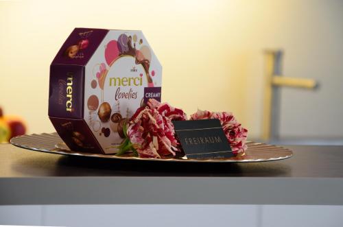 a plate with a cake and a box on a table at Freiraum Urlaubsapartment in Villach