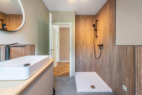 a bathroom with a white sink and a shower at Anker in Papendorf