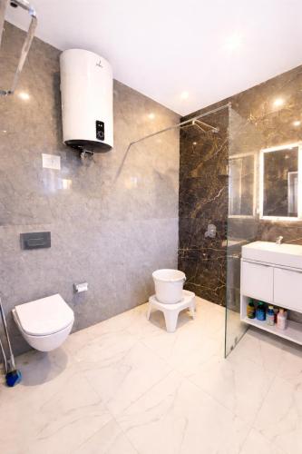 a bathroom with a toilet and a sink and a shower at Hotel Town Star in Srinagar