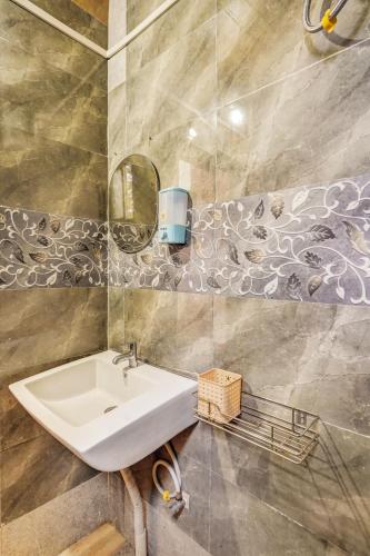 a bathroom with a sink and a mirror at Falcon's Retreat in Pune