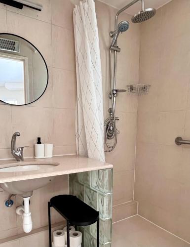 a bathroom with a sink and a shower at Galilee Nook in Kefar Weradim