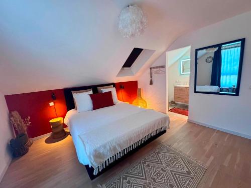 a bedroom with a large bed and a tv at La Pacha, chambre d'hôtes in Spa