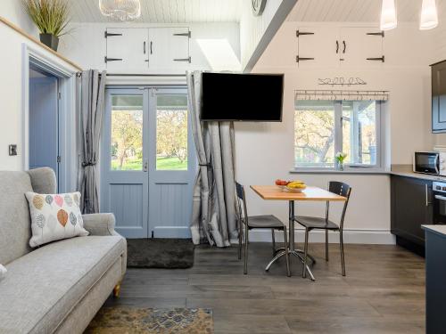 a living room with a couch and a table at The Pavilion in Swaton