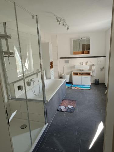 a bathroom with a shower and a tub and a sink at Haus Berta in Spremberg