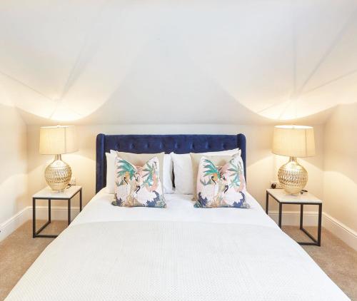 a bedroom with a large bed with two lamps at The Penthouse Retreat in Whitby