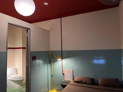 a bedroom with a bed and a bathroom with a toilet at 75 Staytion in Bien Hoa