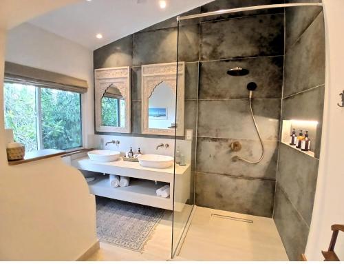 a bathroom with two sinks and a shower at Soroi Blue - Diani Beach in Diani Beach