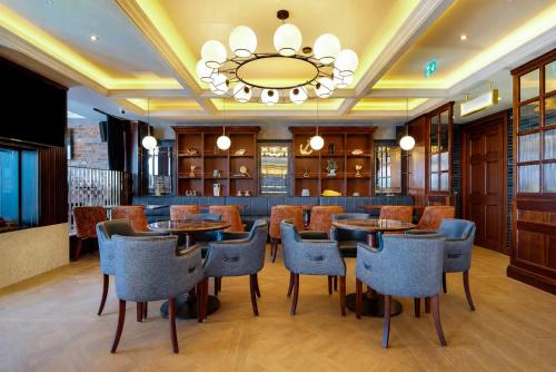 a restaurant with tables and chairs and a chandelier at Bayview Lodge in Downings