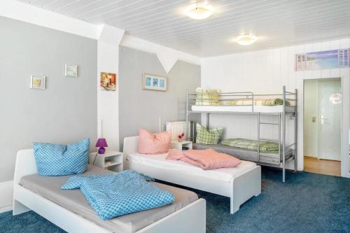 a bedroom with two beds and a bunk bed at Pension in Malchin in Malchin