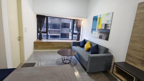 a living room with a couch and a window at Imperio A1910 Studio Bathtud Netflix Parking in Malacca