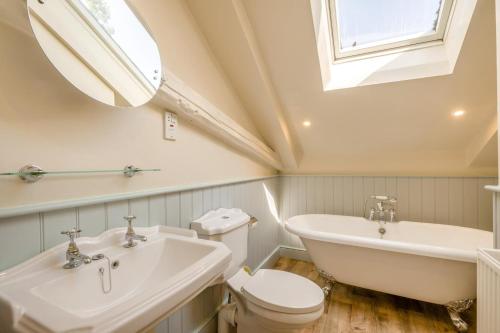 a bathroom with a sink and a toilet and a mirror at 6 Bed in Norwich oc-42594 in Shelton