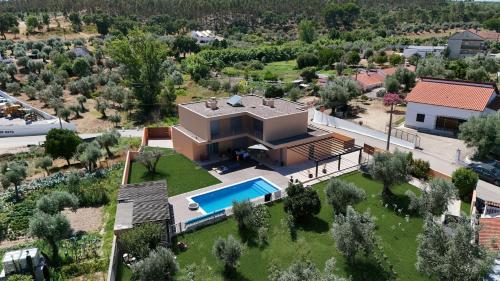 an aerial view of a house with a swimming pool at L'École Villa Nature in Abrantes
