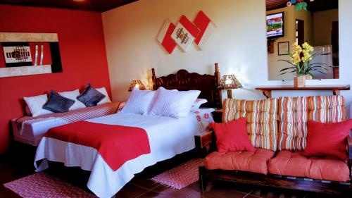 1 dormitorio rojo con 2 camas y sofá en Pousada Amor Perfeito en Visconde De Maua