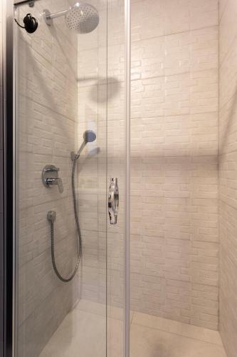 a shower with a glass door in a bathroom at Kargı Suites Datça in Datca