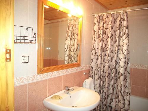 a bathroom with a sink and a shower curtain at Casa la Cuadreta in Calvera