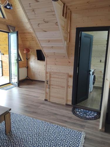 a living room with a large screen tv in a cabin at Cottage MTIS DZIRSHI in Ach'khoti