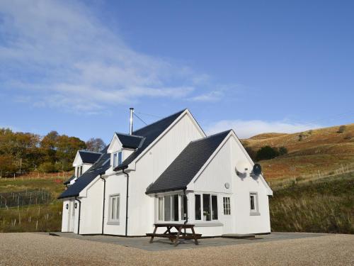a white house with a black roof at Lily Lodge - Uk31958 in Dibaig