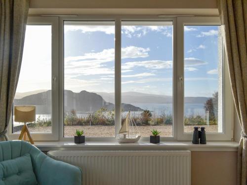 a large window with a view of the ocean at Lily Lodge - Uk31958 in Dibaig