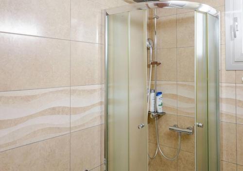 a shower with a glass door in a bathroom at Lighthouse Seafront Panorama - Kato Paphos Central in Paphos