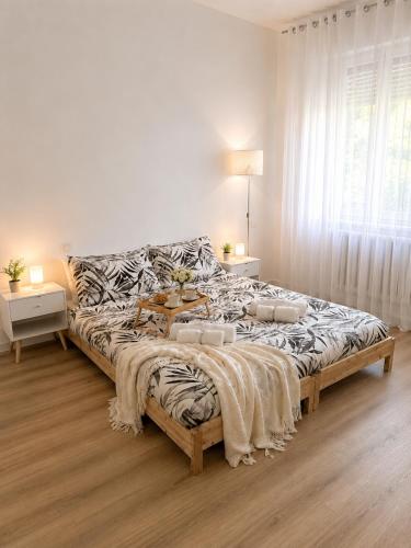 a bedroom with a large bed with a zebra print blanket at Near Airport Malpensa Pvt Room with Pvt Bath and Kitchen Check-in 24h in Legnano