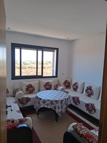 a living room with a couch and a table at Modern Apartment with Pool & Sea View in Casablanca