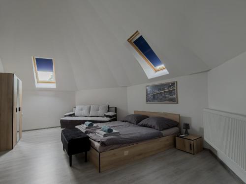 a bedroom with a bed and a couch in it at Crystalapartmanhaz in Gyula