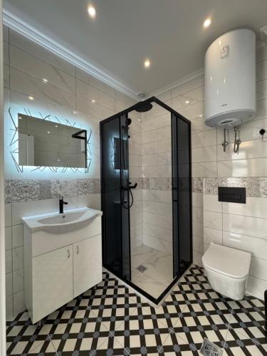 a bathroom with a shower and a sink and a toilet at Paradise Luxury in Ulcinj