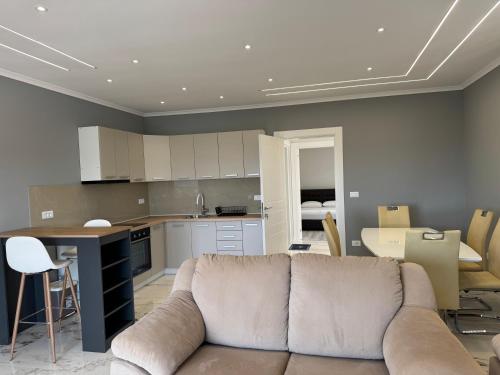 a living room with a couch and a kitchen at Paradise Luxury in Ulcinj