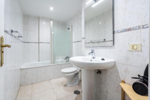 a white bathroom with a sink and a toilet at La Posadilla in Adeje